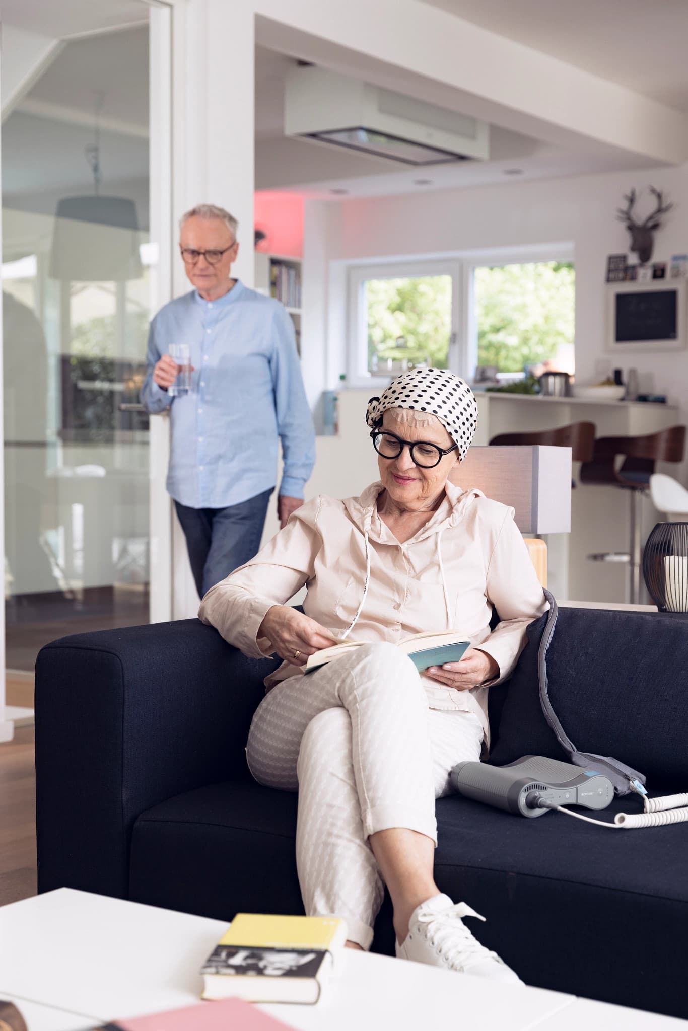 Smiling woman wearing a white lab coat and stethoscope in a bright modern medical clinic