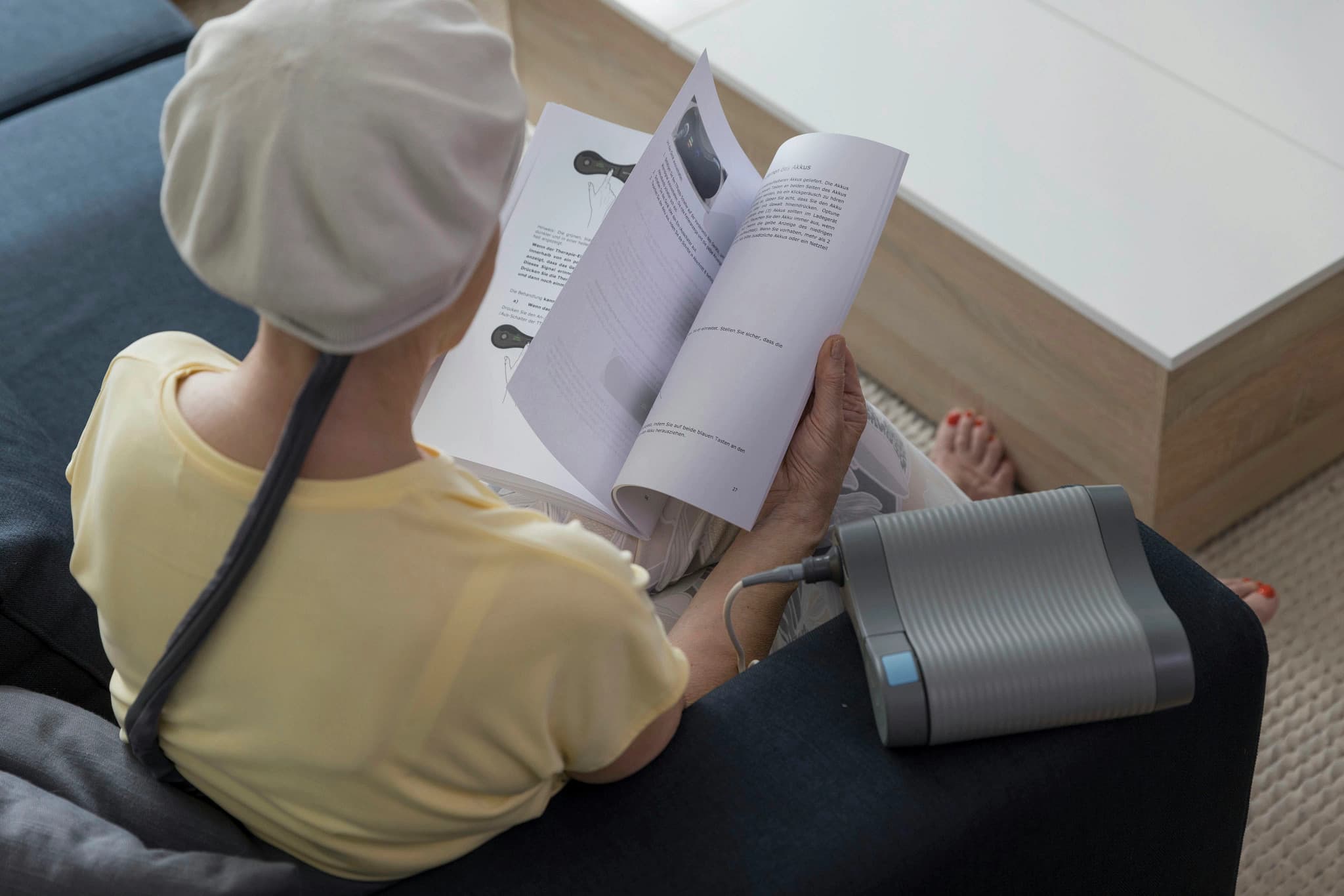 Smiling healthcare professional wearing a lab coat using a tablet device in a modern medical facility
