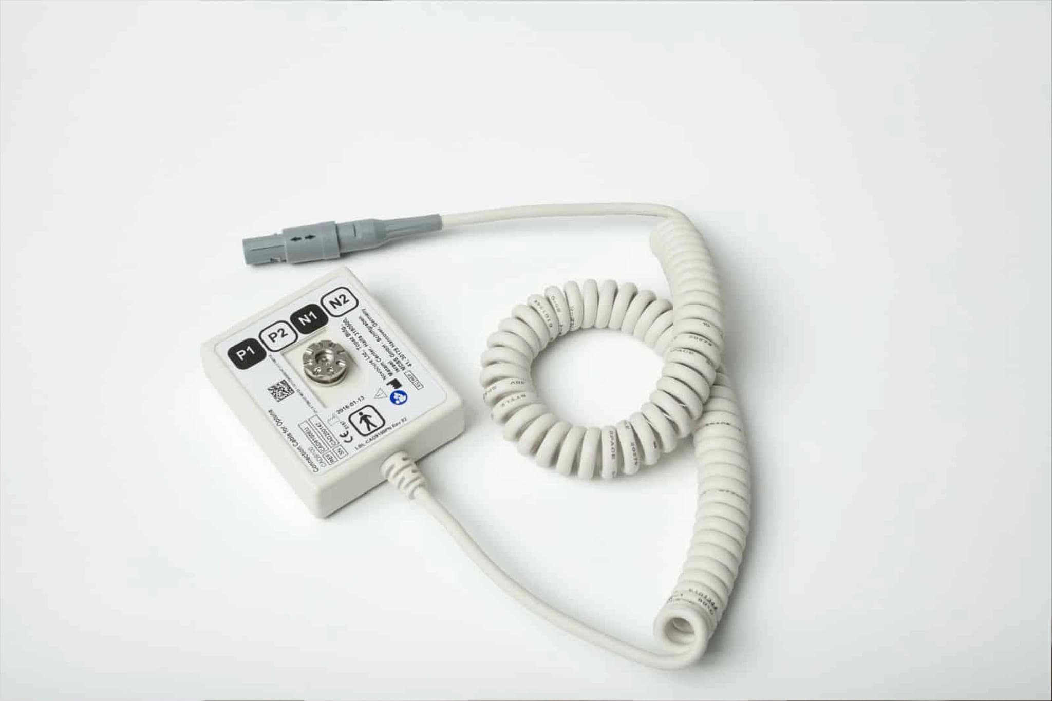 Close-up of a medical connection cable and electronic box device used for tumor treatment