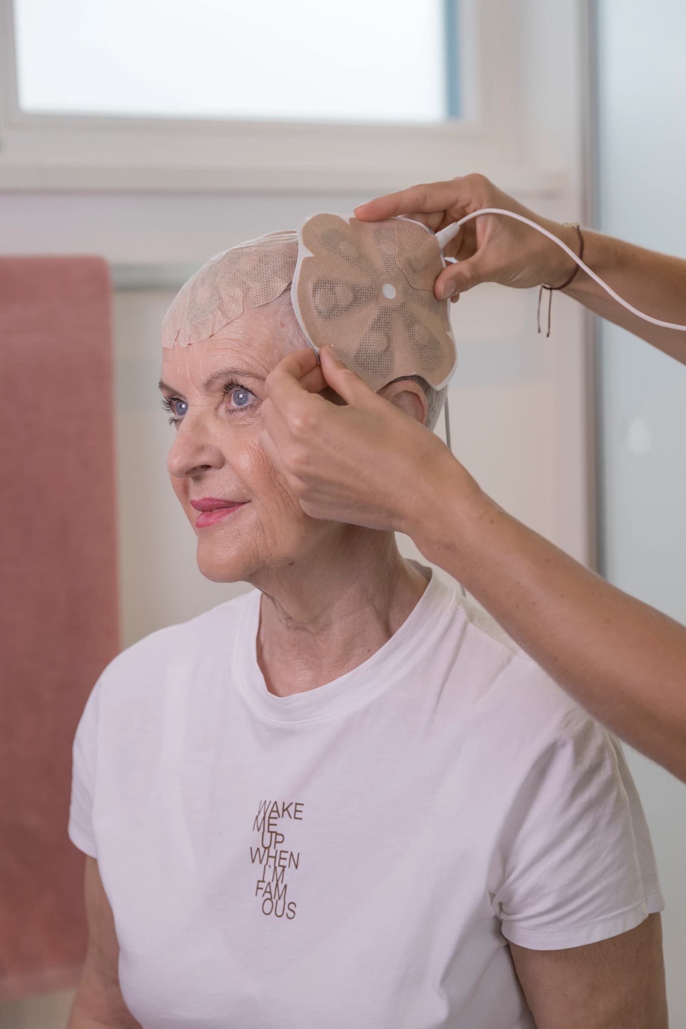 Smiling healthcare professional in a white lab coat working with medical equipment in a bright modern clinic